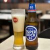 Chilled Super Bock 0.0% beer with glass in a Porto cafe setting.